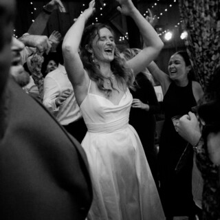 Bride celebrating on the dance floor at a joyful rustic wedding in New Gloucester, Maine.