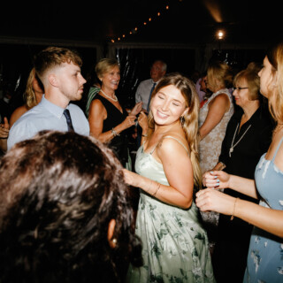Guests dancing under string lights at Moraine Farm wedding reception in Beverly, Massachusetts.