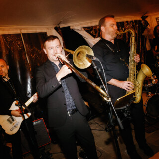 Live jazz band performing indoors under warm golden lights at Moraine Farm Beverly MA.