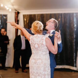 Smiling couple shares a joyful first dance at Moraine Farm wedding in Beverly, Massachusetts.