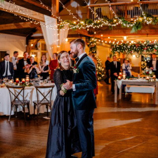 Groom and mother share emotional dance under warm lights at Mountain Top Inn wedding.