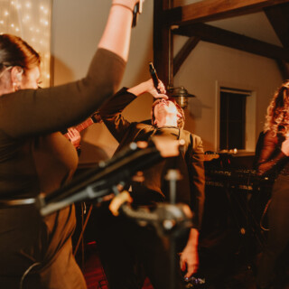 Energetic live band performing passionately at intimate indoor wedding venue in Chittenden, Vermont