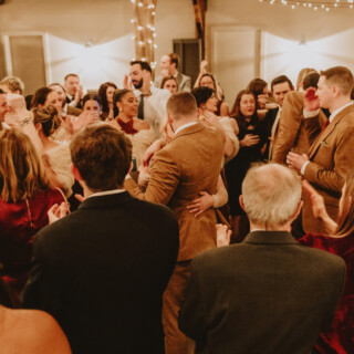 Joyful wedding reception at Mountain Top Resort with guests celebrating under warm string lights.