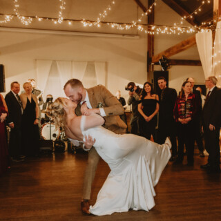 Bride and groom share a romantic first dance dip at Mountain Top Resort wedding in Vermont.
