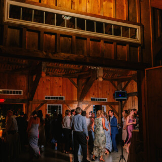 Guests dancing at a rustic barn wedding reception at Timber Hill Farm in Gilford, New Hampshire.