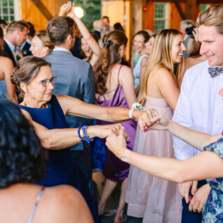 Guests joyfully dancing at Timber Hill Farm wedding reception in Gilford, New Hampshire.