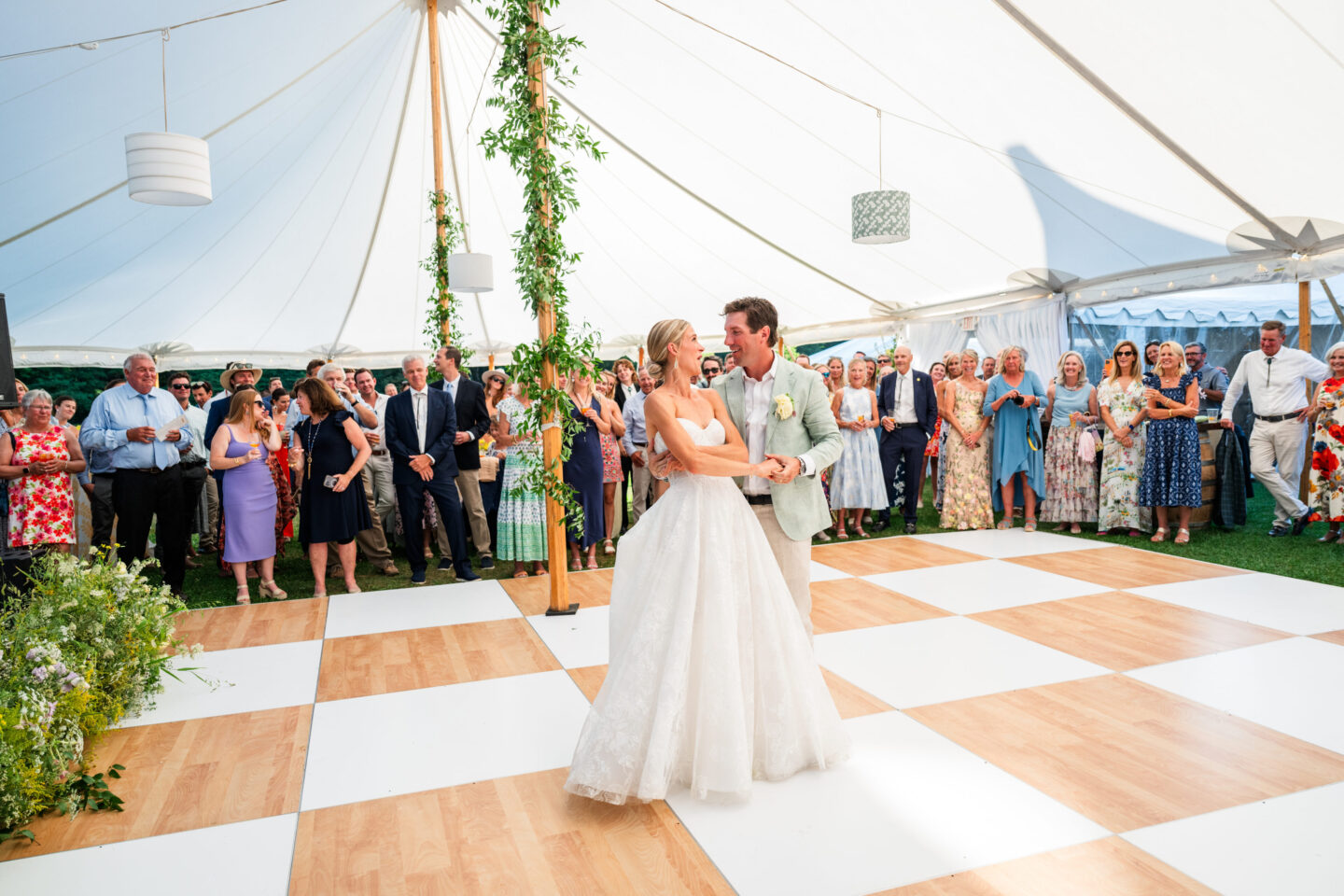 Bride and groom sharing first dance under elegant white tent at Vermont wedding celebration.