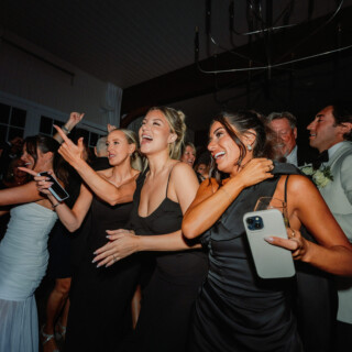 Elegant wedding guests laughing and dancing at Wychmere Beach Club in Harwich, Massachusetts.