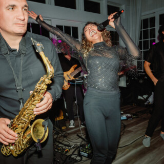 Live band performance with energetic singer and saxophonist at Wychmere Beach Club, Harwich MA.