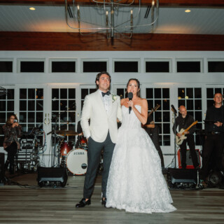 Bride and groom give a joyful toast at Wychmere Beach Club wedding in Harwich, Massachusetts.
