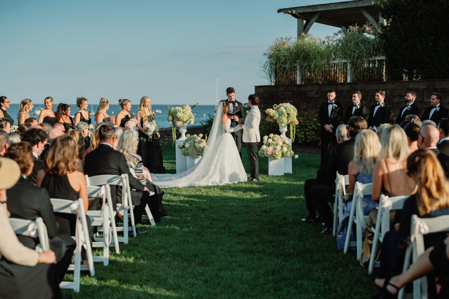 Bride and groom exchange vows at romantic seaside wedding ceremony in Harwich, Massachusetts.